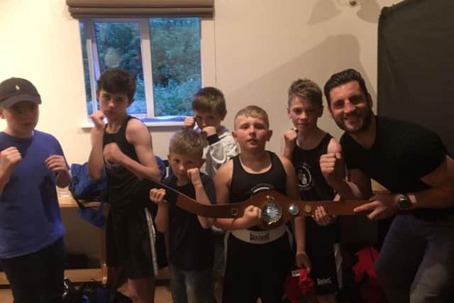 Peterboroughs Southern Area champion Cello Renda presented the trophies at the Whittlesey Amateur Boxing Club show. He is pictured with the Whittlesey junior boxers.