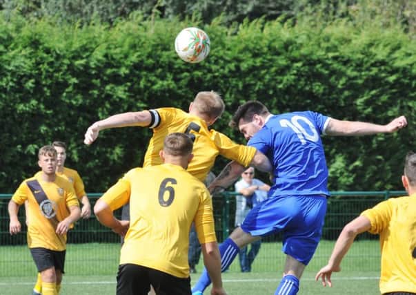 Tom Waumsley (blue) hit a hat-trick for Yaxley in the Hinchingbrooke Cup FInal.