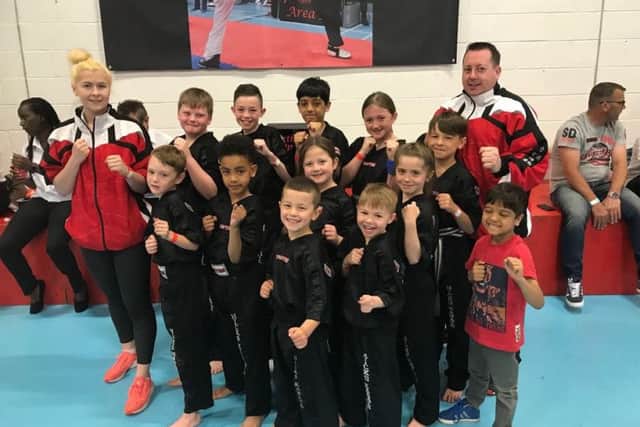 The Hicks Karate School team that did well at the Northants Open. From the left are, back, Atlanta Hickman (instructor), Warren Bothamley, Aaron Leonard, Shiv Panchal, Lucy Hicks, Denas Jankauskas, Andrew Hicks (chief instructor), middle, Oliver Profitt, Joell Celaire, Sophie Hicks, Sophie Doyle, front, Tajus Jankauskas, Joshua Leonard and Ravi Panchal.