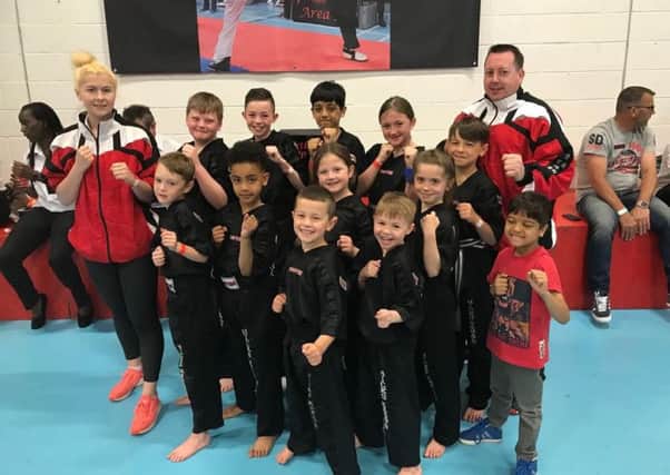 The Hicks Karate School team that did well at the Northants Open. From the left are, back, Atlanta Hickman (instructor), Warren Bothamley, Aaron Leonard, Shiv Panchal, Lucy Hicks, Denas Jankauskas, Andrew Hicks (chief instructor), middle, Oliver Profitt, Joell Celaire, Sophie Hicks, Sophie Doyle, front, Tajus Jankauskas, Joshua Leonard and Ravi Panchal.