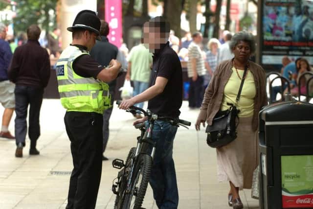 A cyclist is stopped in Bridge Street