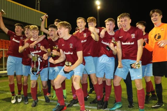 Deeping Under 18s celebrate their league and cup double.