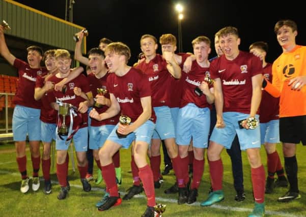 Deeping Under 18s celebrate their league and cup double.