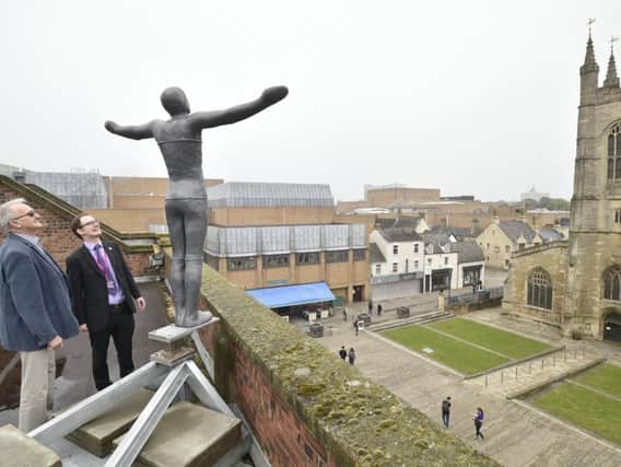 Peterborough City Council leader Cllr John Holdich and Vivacity director of culture Richard Hunt next to one of the sculptures on top of the Leeds Building Society building