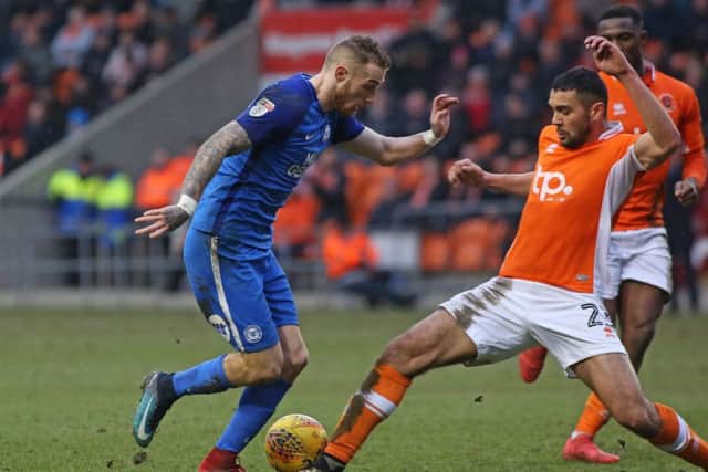 Colin Daniel (right) tackles Marcus Maddison at Bloomfield Road  last season.