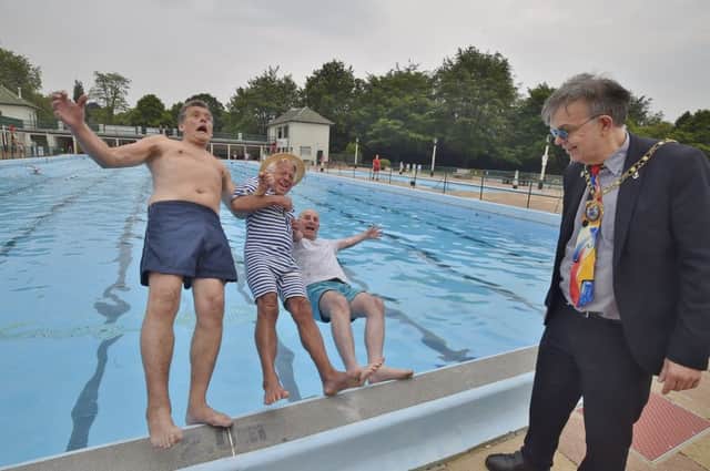Opening of the Lido 2018. The first in, John Peach, Bill Marriott and Andy Lowings get a helping hand from Mayor of Peterborough Coun. Chris Ash EMN-180526-180921009