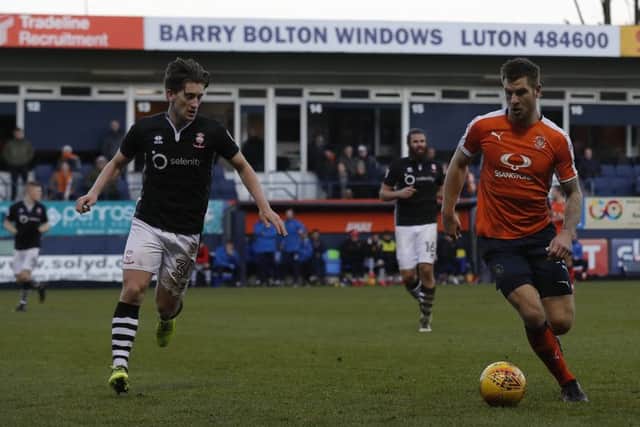 Alex Woodyard (left) in action for Lincoln against Luton.