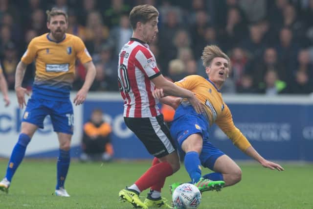 Alex Woodyard (left) in action for Lincoln.