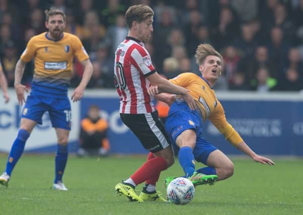 Alex Woodyard (left) in action for Lincoln.