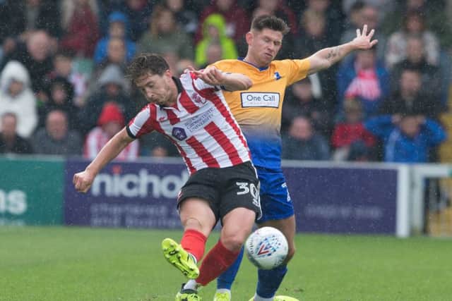 New Posh signing Alex Woodyard (left) in action for Lincoln City.