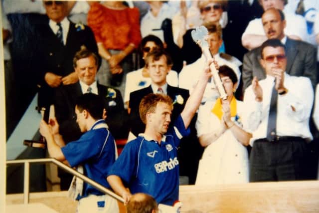 Posh captain Mick Halsall lifts the League One play-off trophy at Wembley in 1992.