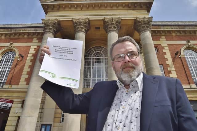 Cllr David Seaton with a copy of the budget