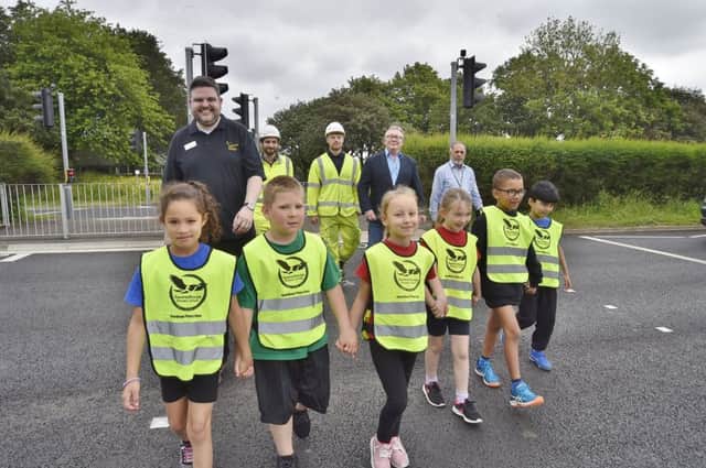 Opening of new Toucan crossing at Gresley Way, Westwood. Pupils from Ravensthorpe primary school with head teacher Martin Fry with Rory Blackburn and Rylan Orchard from Peterborough Highways with Councillors Peter Hiller and Gul Nawaz EMN-180906-093658009