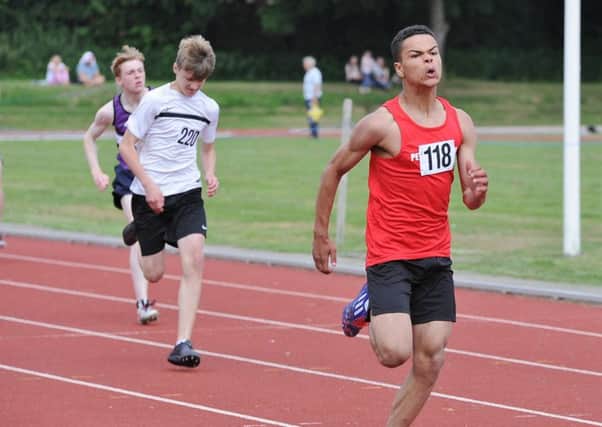 Jason Bogle storms to victory in the Under 15 Boys 200m.