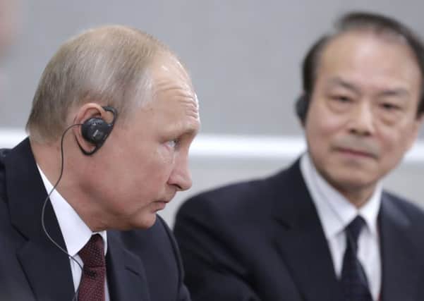 Vladimir Putin (left).
