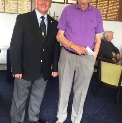 Wally Rushton (85) received his prize from Milton seniors captain Steve Moule (left).