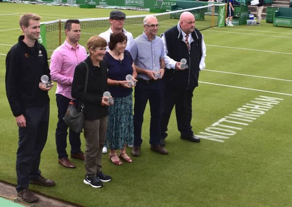 City of Peterborough tennis manager Bill Skead (front, second right) and coach Dean Ross-Hamilton (back, right) on court at Nottingham Tennis Centre with the club's prestigious award. Photo: Georffrey Smith.