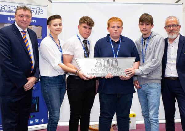Austen Adam, divisional MD for Metalcraft, left, with Neil Kirby, apprentice trainer, right, and some of the new apprentices.

Picture by Terry Harris. THA