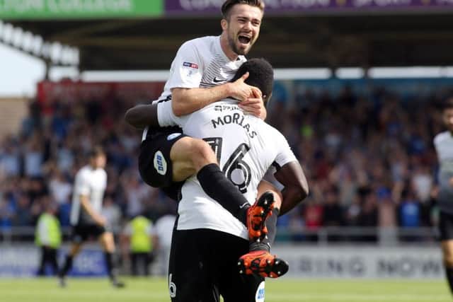 Gwion Edwards celebrates a Posh goal at Northampton last season.