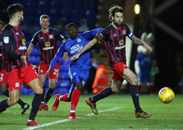 Idris Kanu of Peterborough United in action with Charlie Mulgrew of Blackburn Rovers. Picture: Joe Dent