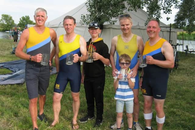 The winning Masters D coxed four of Iain Cameron, James Baile, cox Tom Calver, Steve Ackerman (with his son) and Kenny Low.