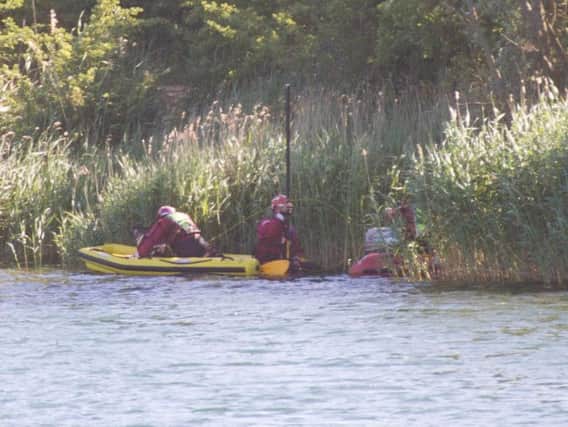 Specialist divers have been called in to help with the search at Crown Lakes. Photo: Terry Harris
