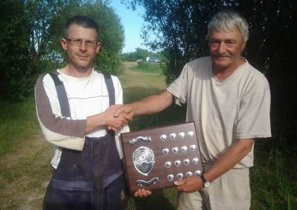 Cock Inn's Chris Shortland receives the Challenge Shield from Hotpoint's Peter Sanderson.