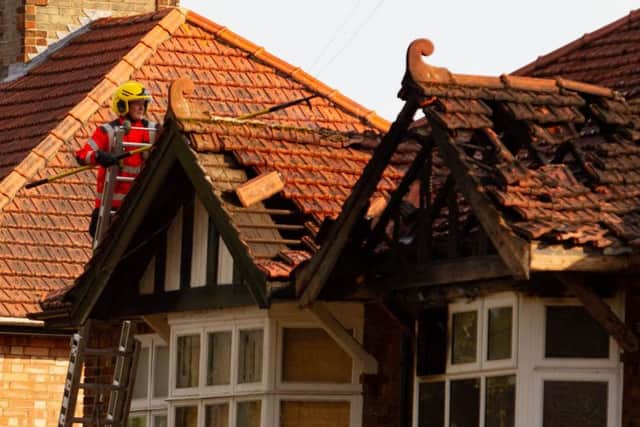 Fire crews survey the aftermath of the fire. Photo: Terry Harris