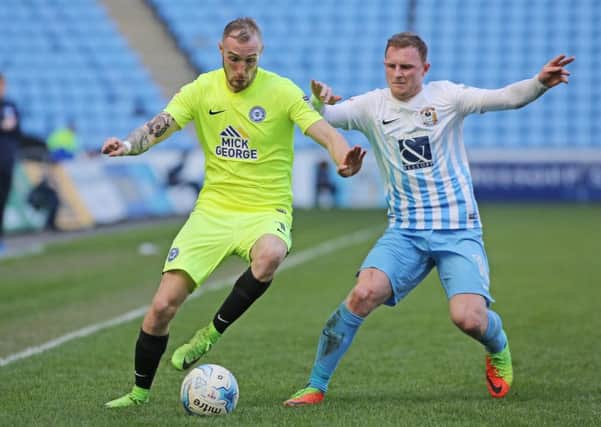 Marcus Maddison in action for Posh at the Ricoh Arena.