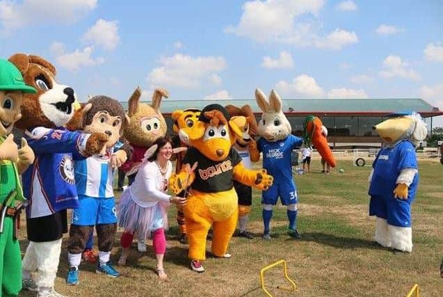 The mascots eagerly prepare for the obstacle course