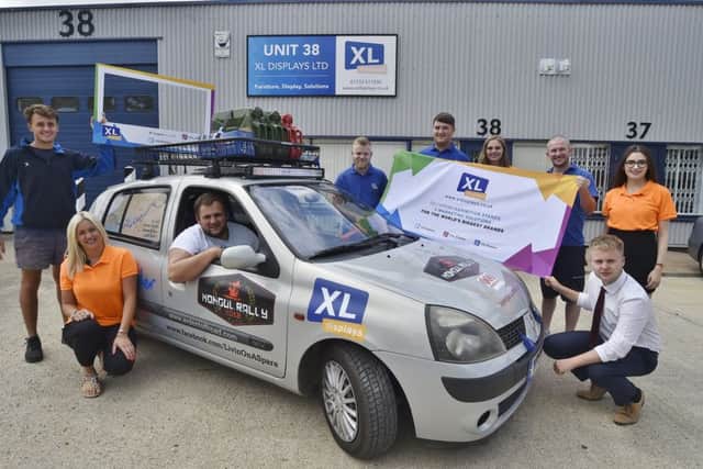 Mongol Rally drivers Josh Allen and Ollie Frisby and their vehicle Livin in a Spare with sponsors staff from XL Displays at Orton Southgate before leaving for the rally on Thursday - raising funds for Sue Ryder. EMN-181107-143152009