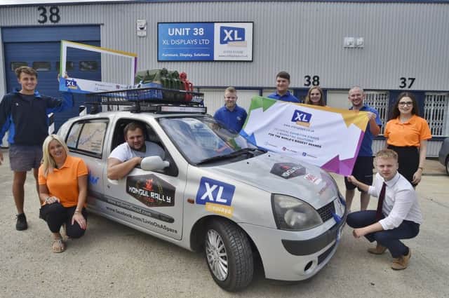 Mongol Rally drivers Josh Allen and Ollie Frisby and their vehicle Livin in a Spare with sponsors staff from XL Displays at Orton Southgate before leaving for the rally on Thursday -  raising funds for Sue Ryder. EMN-181107-143152009