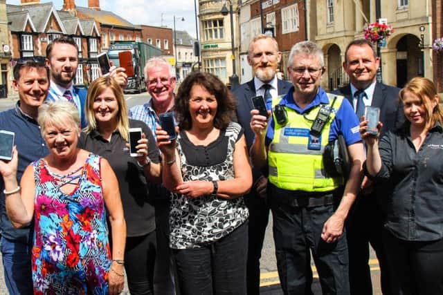 Launch of Business Watch, from left, back, Chamber of Commerce membership manager Justin Pover, scheme co-ordinator for the chamber, Steve Jackson, SKDC community resilience lead Mark Jones, SKDC Cabinet Member for Retail and Visitor Economy Cllr Nick Robins, middle row, James and Stephanie Romaine of Stephanies Flowers, Ann West, of Spice of Life; PCSO Graeme Parrott; Billy Eady of The Nags Head, front, Val Coddington, of Harrison and Dunn hardware shop.