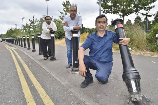Intkhab Ahmed, Mohammed Aftab and Iftikhar Ahmed (the owner of Najib food store) with one of the  plastic bollards EMN-181007-163622009