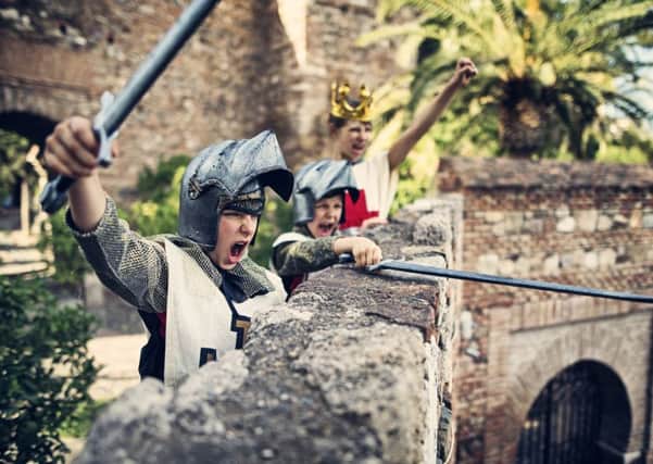 Little knights and the young queen cheering on the castle walls. Theay have defended the castle from the assault.