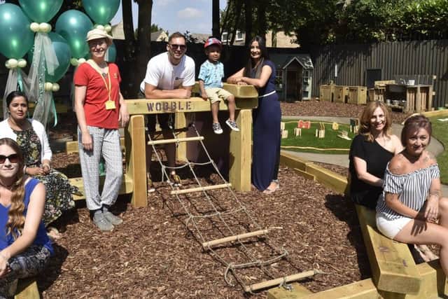 Staff and parents at the Longthorpe pre-school with their new outdoor garden and play area at the village hall. EMN-180707-181450009