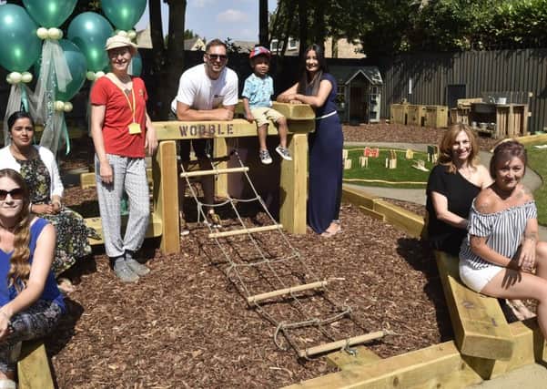 Staff and parents at the Longthorpe pre-school with their new outdoor garden and play area at the village hall. EMN-180707-181450009