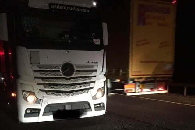 The lorry pulled over on Frank Perkins Parkway pointing the wrong way as other traffic flashes past it in the opposite direction. Photo: @roadpolicebch