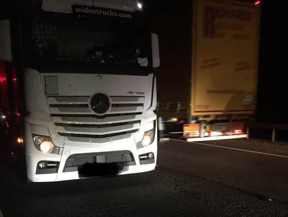 The lorry pulled over on Frank Perkins Parkway pointing the wrong way as other traffic flashes past it in the opposite direction. Photo: @roadpolicebch