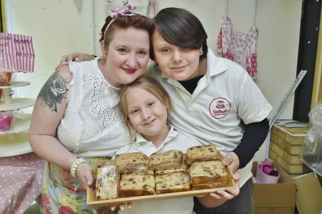 Food and Drink Festival at Peterborough Market. Selling cakes  Victoria Thompson and her children Ruth (8) and Luke (11) EMN-180721-195659009