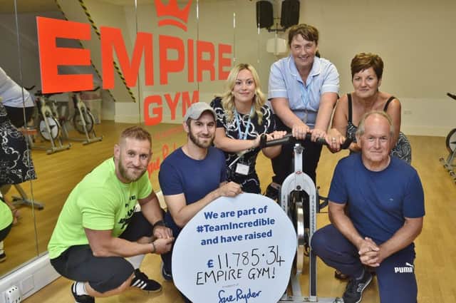 Matt Weston with his brother Dave, dad Steve and mum Lesley handing funds raised through the Empire Gym at Market Deeping to Joely Garner and nurse Debbie Roberts from Sue Ryder. EMN-180723-185750009