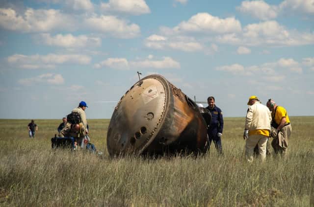 Russian support personnel work around the Soyuz TMA-19M spacecraft after it landed with Expedition 47 crew members Tim Kopra of NASA, Tim Peake of the European Space Agency, and Yuri Malenchenko of Roscosmos near the town of Zhezkazgan, Kazakhstan on Saturday, June 18, 2016. Kopra, Peake, and Malenchenko are returning after six months in space where they served as members of the Expedition 46 and 47 crews onboard the International Space Station. Photo Credit: (NASA/Bill Ingalls) NHQ201606180027