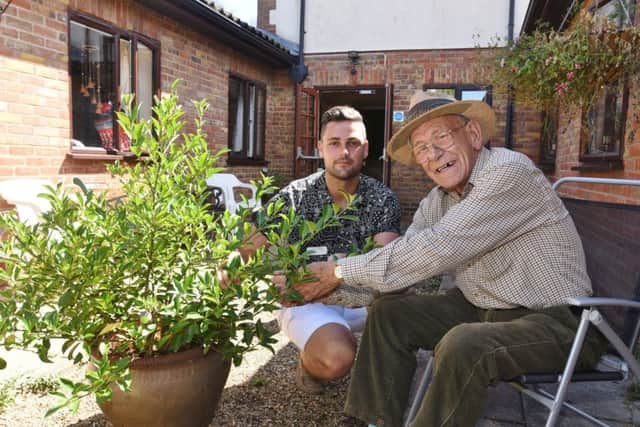Tudor Care Home, Stanground manager Ronnie Lane with resident Michael Cheetham in the courtyard which is in need of renovation. EMN-180731-131453009