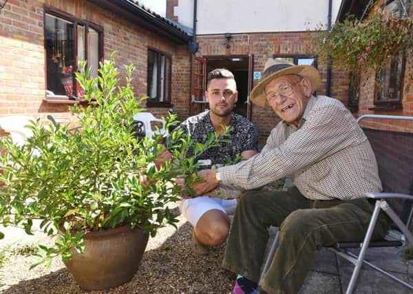 Tudor Care Home, Stanground manager Ronnie Lane with resident Michael Cheetham in the courtyard which is in need of renovation. EMN-180731-131453009