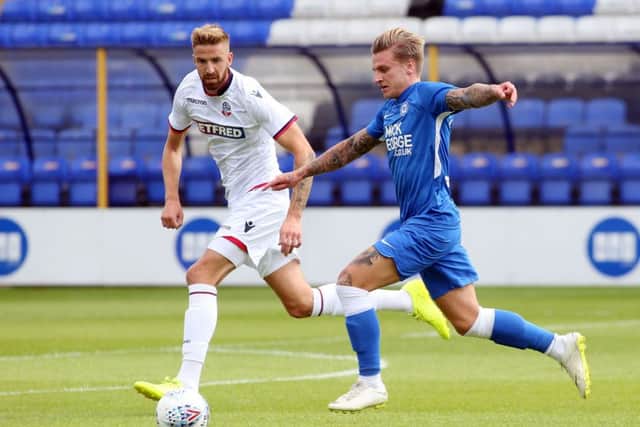 Posh striker Jason Cummings takes on Bolton's Mark Beevers. Photo: Joe Dent/theposh.com.