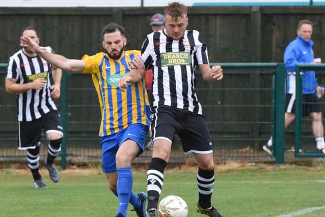 Jake Sansby (stripes) of Peterborough Northern Star in action against Wellingborough Town. Photo: Chantelle McDonald. @cmcdphotos.