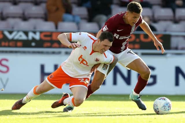 Callum Cooke (left) in action for Blackpool.