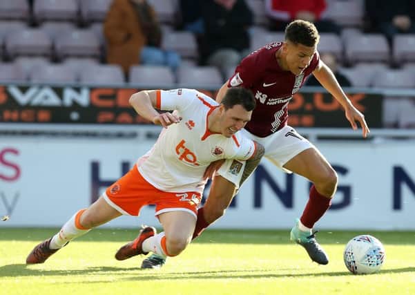 Callum Cooke (left) in action for Blackpool.