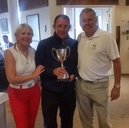 Greetham Valley club champion Trevor Smith (centre) with club captains Sue Brand and Paul Clegg.