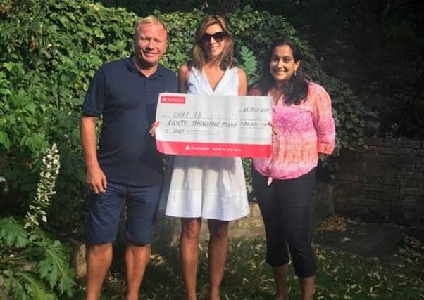 Zoe Crowson and Steven Arnold presenting the cheque from The Phoebe Research Fund  to Charmila Collins  from CURE EB